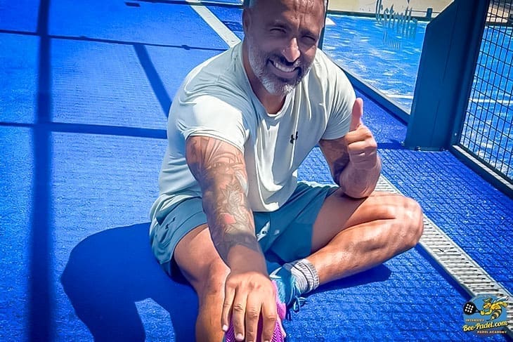 Happy Padel Player Relaxing on Dry Court Thanks to Courtcovers All-Weather Protection during Bee-Padel.com Padel Clinic Happy padel player sitting on a dry court after rain and sandstorm, with the court protected by Courtcovers All-Weather Padel Court Cover. During Padel Clinic of Bee-padel.com