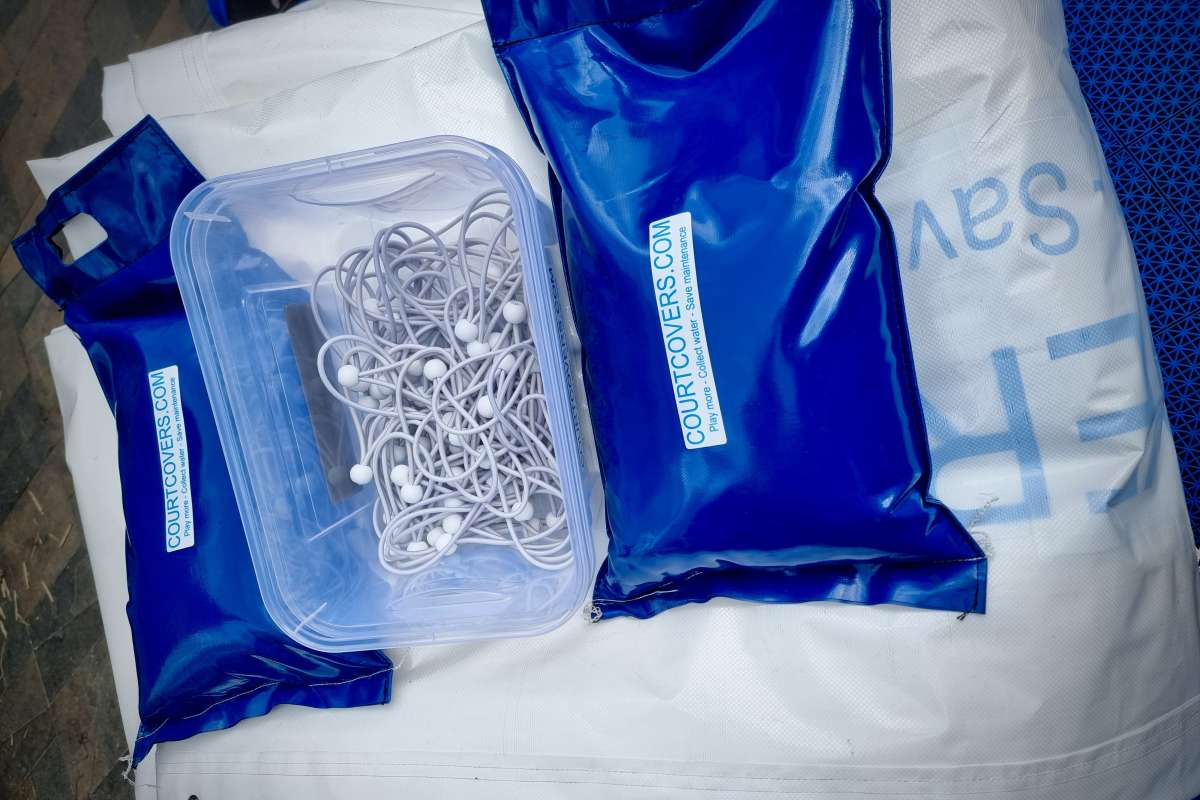 Detailed view of durable bands and elastic straps used to fix the Padel Court Cover Protection System securely to the court by Courtcovers.com.